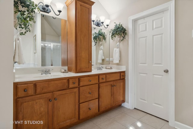 bathroom with vaulted ceiling, double vanity, tile patterned flooring, and a sink