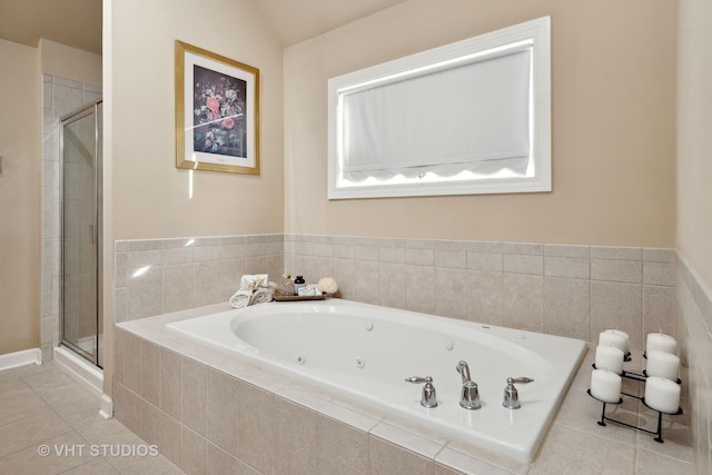 bathroom with a stall shower, tile patterned flooring, and a jetted tub