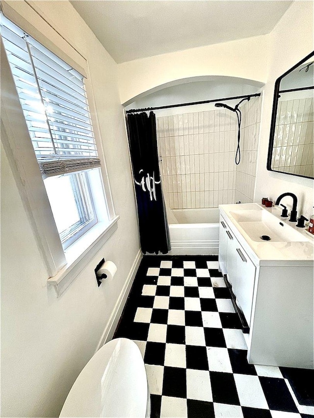 full bathroom with toilet, tile patterned floors, vanity, baseboards, and shower / tub combo with curtain