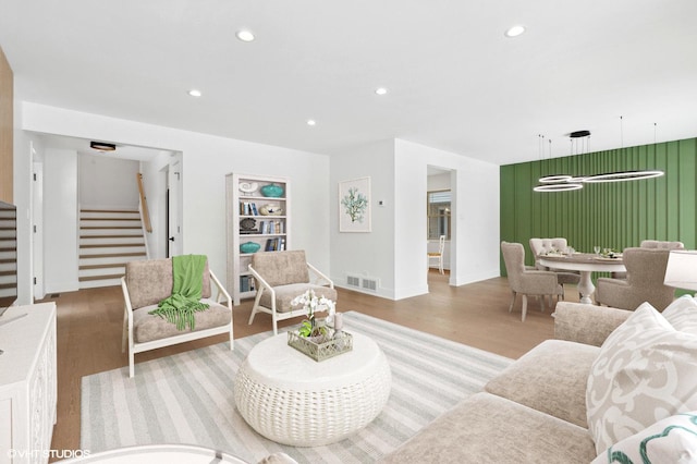 living room featuring stairs, visible vents, and recessed lighting