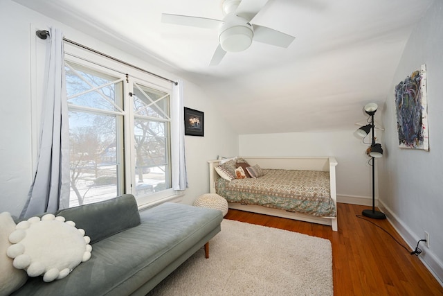 bedroom featuring lofted ceiling, ceiling fan, baseboards, and wood finished floors