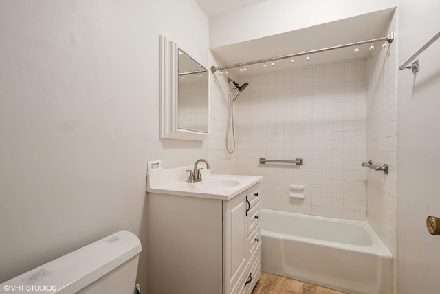 bathroom with shower / bathing tub combination, vanity, and toilet