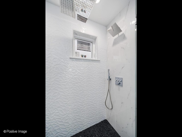 bathroom with tiled shower