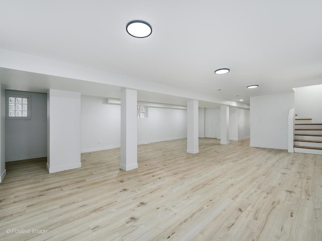 basement with stairway, wood finished floors, and baseboards