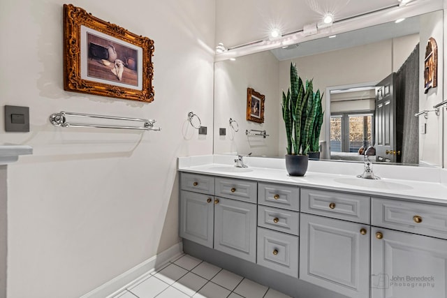 bathroom featuring double vanity, ensuite bath, a sink, and tile patterned floors