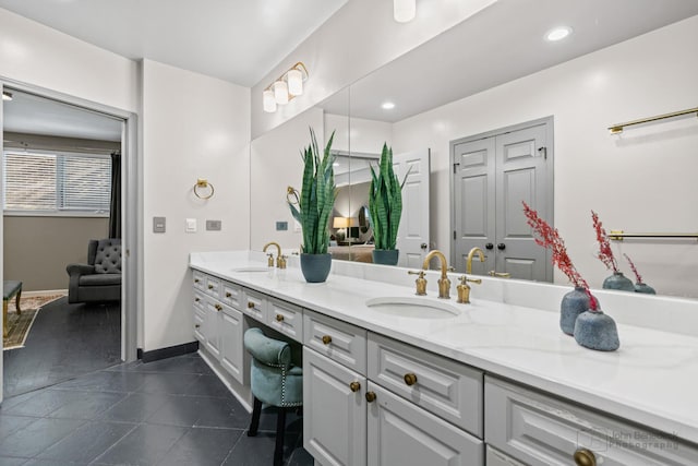 full bathroom with recessed lighting, a sink, baseboards, and double vanity