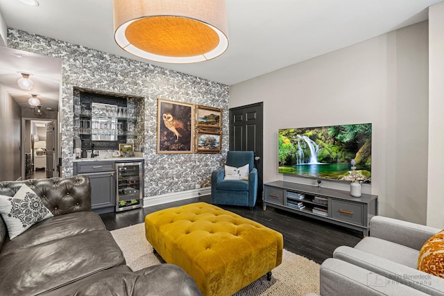 living room with wallpapered walls, baseboards, wine cooler, dark wood-type flooring, and a bar