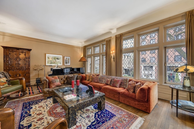 living area featuring ornamental molding and light wood-style floors