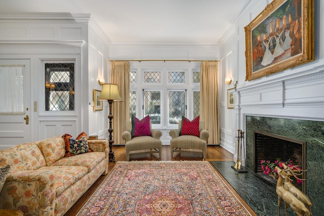 interior space with crown molding, dark wood finished floors, a fireplace, and a decorative wall