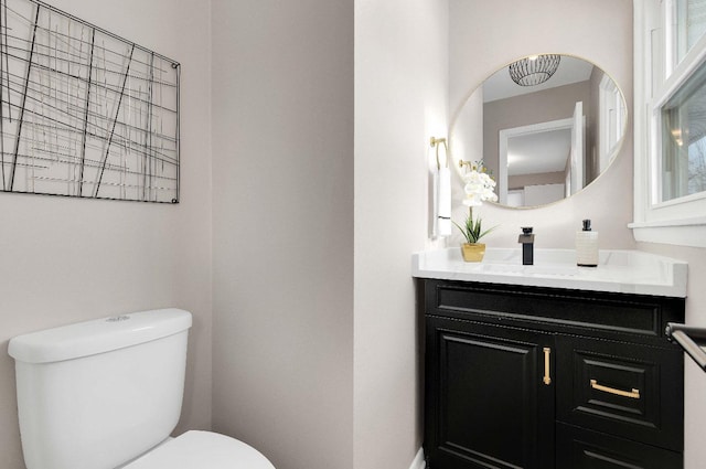 half bath featuring toilet and vanity