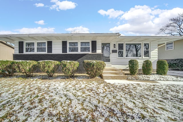 view of front of home featuring entry steps and brick siding