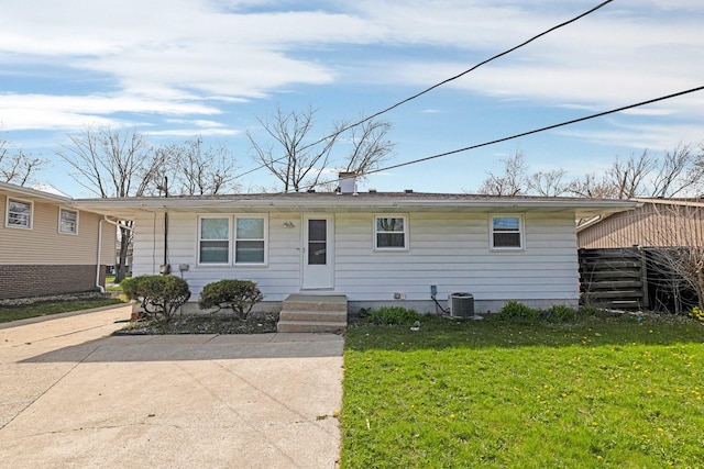ranch-style house featuring central AC and a front yard