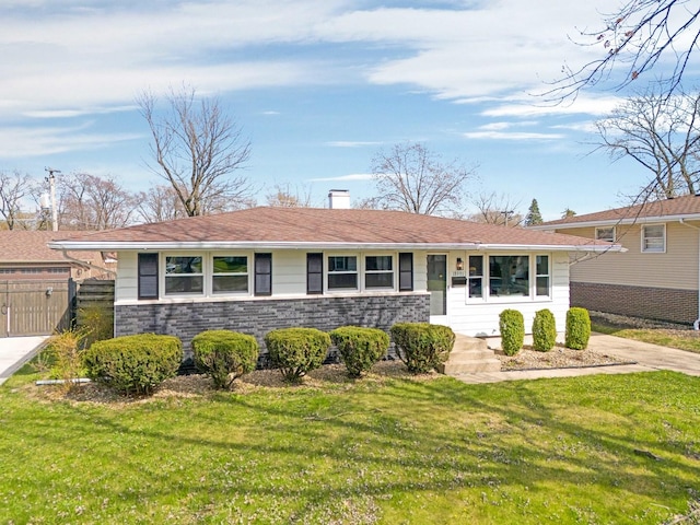 ranch-style home with a chimney, fence, stone siding, and a front yard