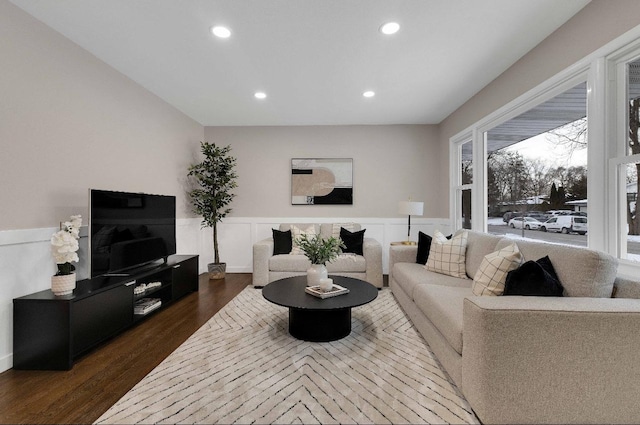 living area featuring a wainscoted wall, dark wood-style flooring, recessed lighting, and a decorative wall