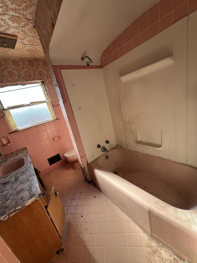 bathroom featuring toilet, visible vents,  shower combination, and vanity