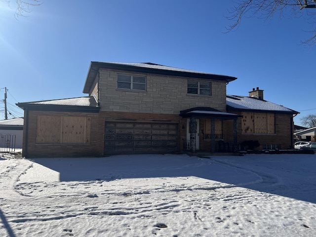 view of front facade featuring an attached garage, stone siding, and a chimney