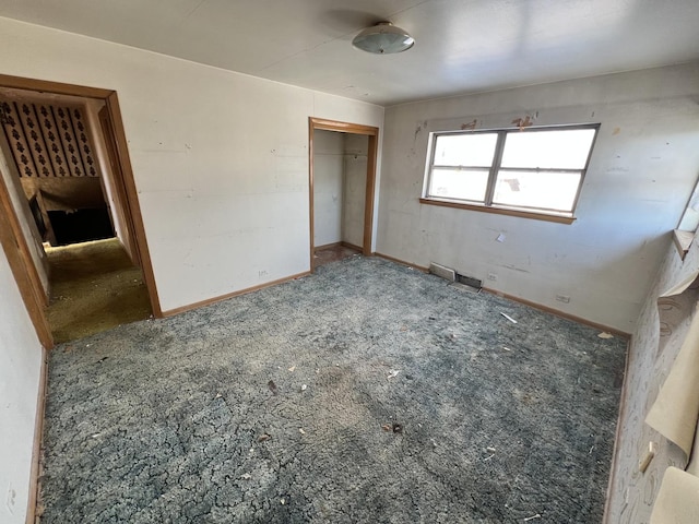 unfurnished bedroom with carpet floors, a closet, and baseboards