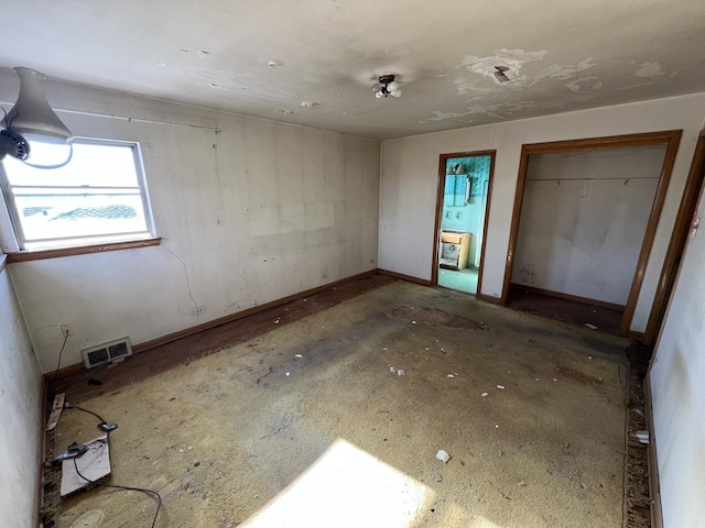 unfurnished bedroom with a closet, visible vents, and baseboards