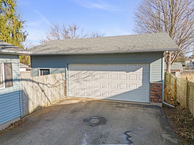 detached garage featuring fence