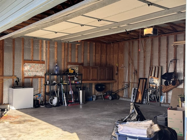 garage with refrigerator and a garage door opener