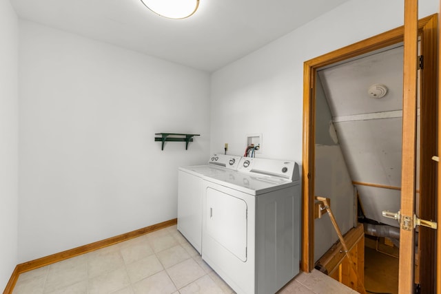 laundry room with baseboards, separate washer and dryer, and laundry area