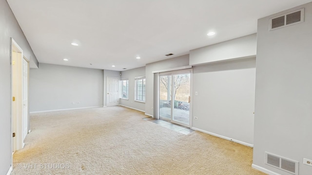 unfurnished room featuring carpet, visible vents, and recessed lighting