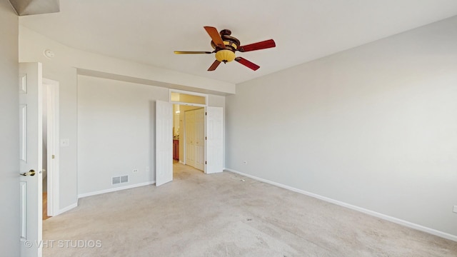 unfurnished bedroom with visible vents, baseboards, and light colored carpet