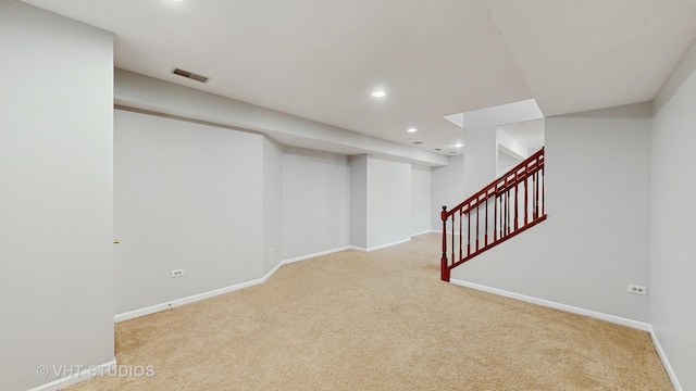 finished basement featuring recessed lighting, visible vents, carpet flooring, baseboards, and stairs