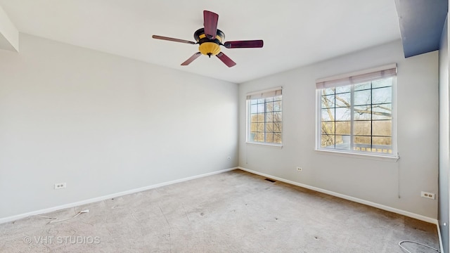 unfurnished room with a ceiling fan, carpet, visible vents, and baseboards