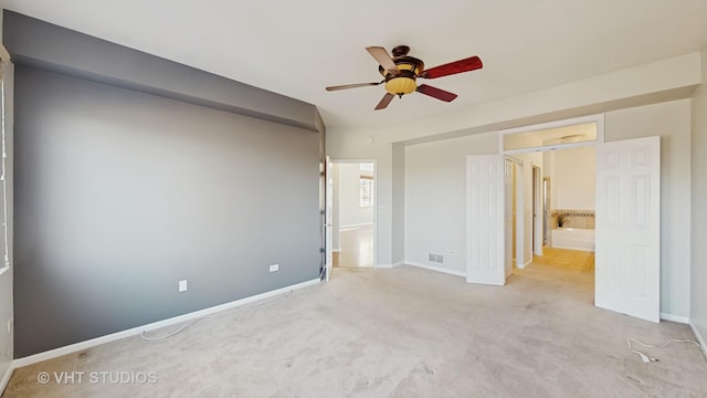 unfurnished bedroom with carpet flooring, visible vents, and baseboards