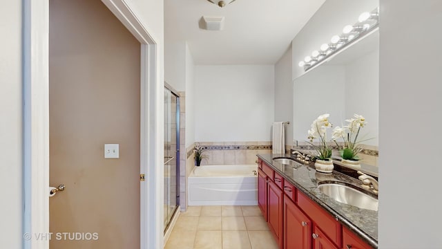 bathroom featuring double vanity, a sink, tile patterned flooring, a shower stall, and a bath