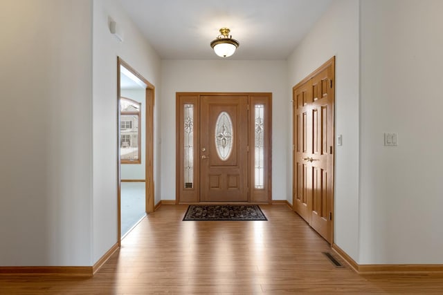 entrance foyer with light wood-type flooring, baseboards, and visible vents