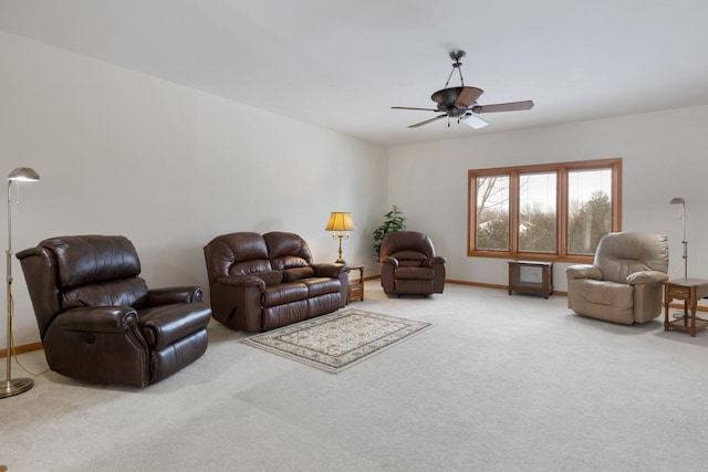 carpeted living room featuring ceiling fan and baseboards