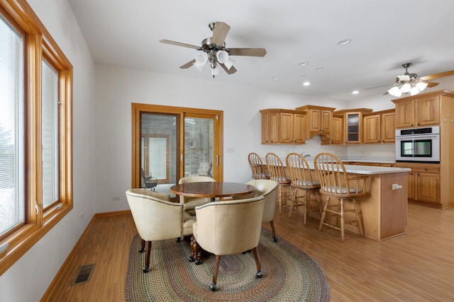 dining area with baseboards, visible vents, a ceiling fan, light wood-style floors, and recessed lighting