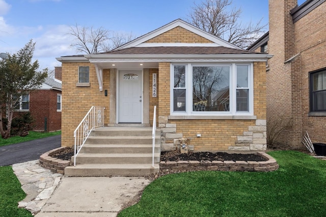 bungalow-style house with brick siding