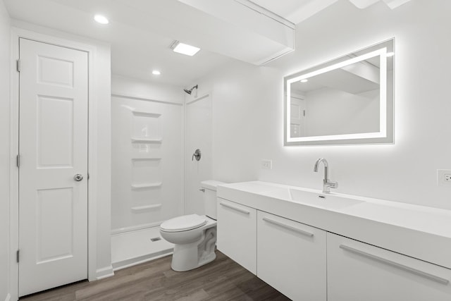 full bath with toilet, wood finished floors, walk in shower, vanity, and recessed lighting