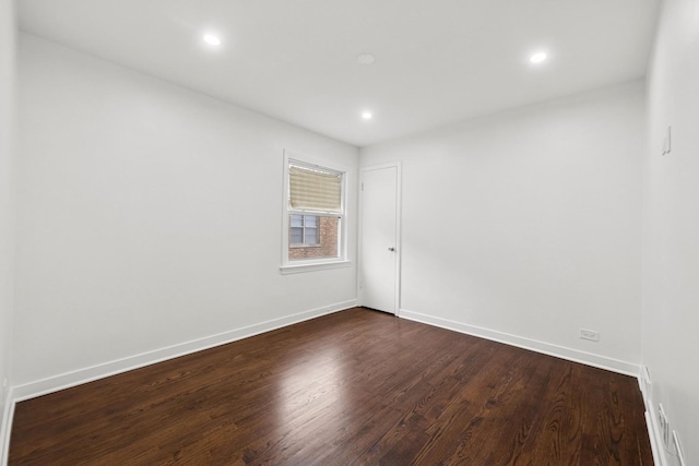 unfurnished room with dark wood-type flooring, recessed lighting, and baseboards