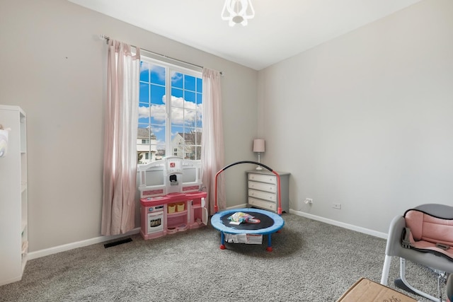 recreation room with carpet floors, visible vents, and baseboards