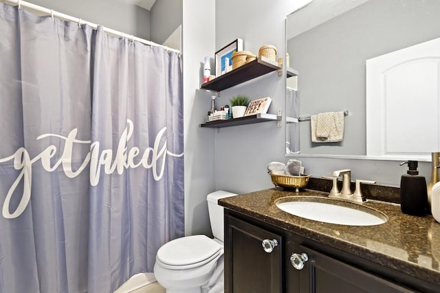 bathroom featuring curtained shower, vanity, and toilet