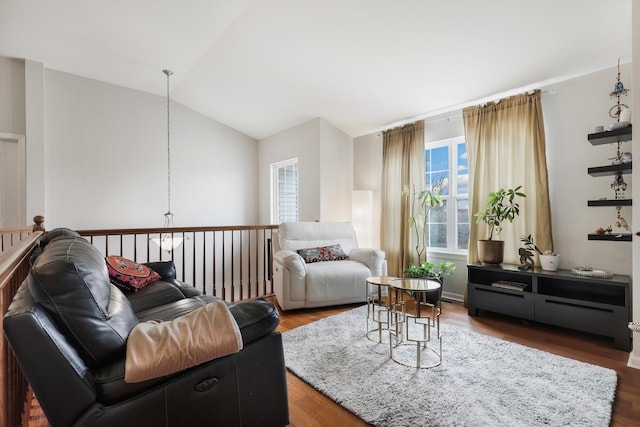 living room with vaulted ceiling and wood finished floors