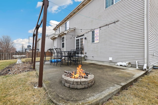 view of patio with fence and a fire pit