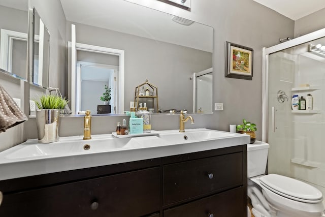 bathroom featuring visible vents, a shower stall, toilet, and vanity