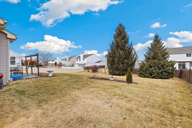 view of yard with a fenced backyard and a residential view