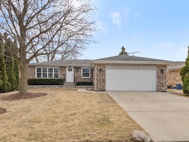 ranch-style house with a garage, a front yard, brick siding, and driveway