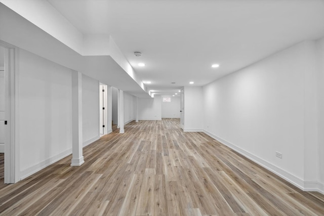 finished below grade area with recessed lighting, light wood-style flooring, and baseboards