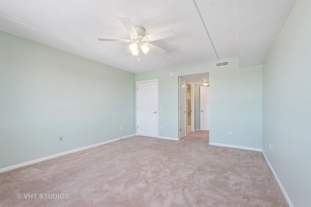 unfurnished bedroom with light carpet, baseboards, visible vents, a ceiling fan, and a textured ceiling