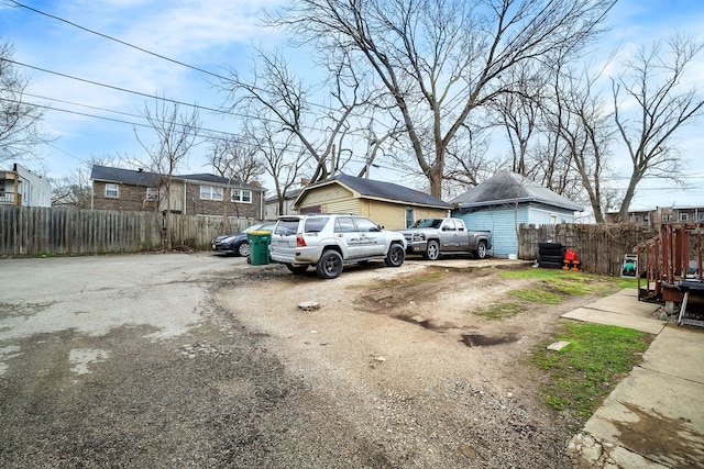 exterior space featuring driveway and fence