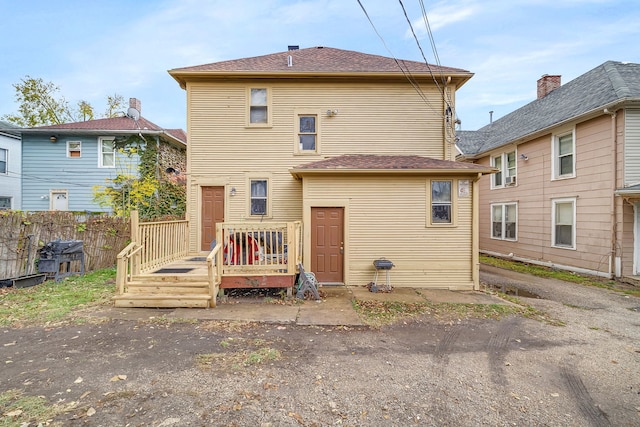 back of property featuring fence