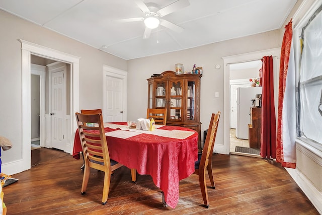 dining room with ceiling fan and dark wood-style flooring