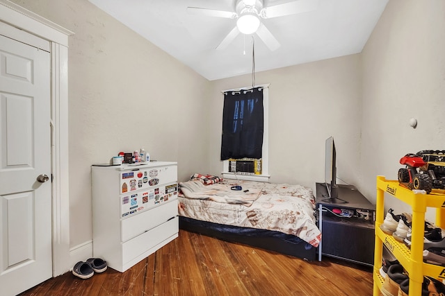 bedroom with a ceiling fan and wood finished floors